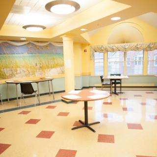 A bright and inviting dining area with yellow walls and modern furnishings.