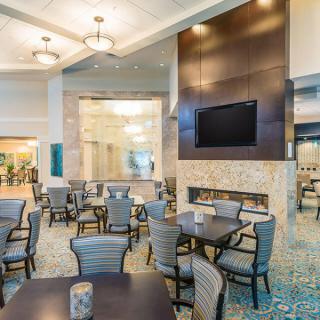 A modern restaurant dining area with tables and chairs arranged neatly, featuring contemporary lighting and d�cor.