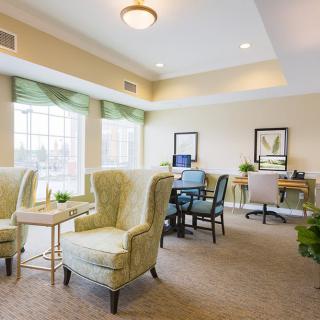 A bright and cozy interior with comfortable seating and a small office area.
