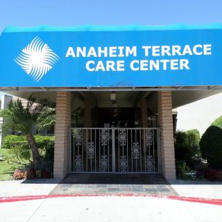 Entrance of Anaheim Terrace Care Center with a blue awning.