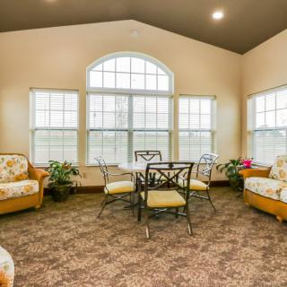 A cozy living room with large windows and comfortable seating.