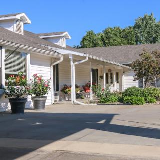 A charming residential home with a well-maintained garden and inviting porch.