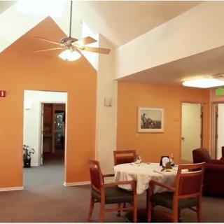 A cozy dining area with a set table and ceiling fan overhead.