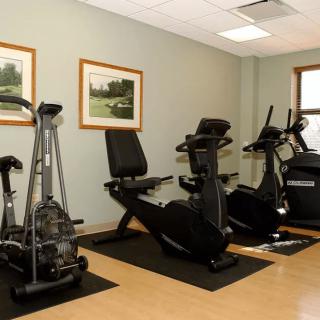 A small gym room with exercise bikes and fitness equipment.
