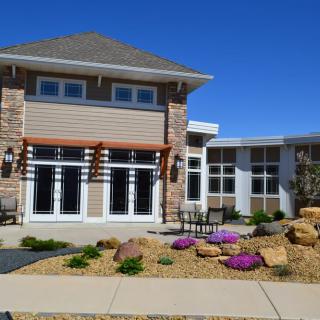 A modern house with landscaped garden and stone accents.