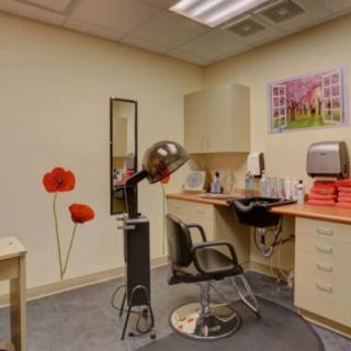 A cozy beauty salon setup with a hair dryer and salon chair.