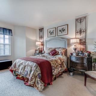 A cozy bedroom with elegant furnishings and decorative accents.