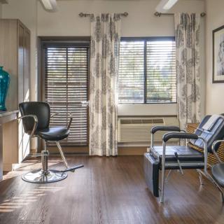 A well-lit salon interior with chairs and modern decor.
