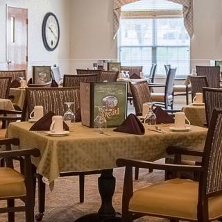 A well-arranged dining area with neatly set tables and chairs, showcasing elegant interior decor.