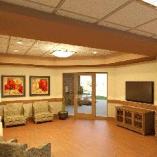 A cozy living room with comfortable seating, a television, and decorative artwork on the walls.