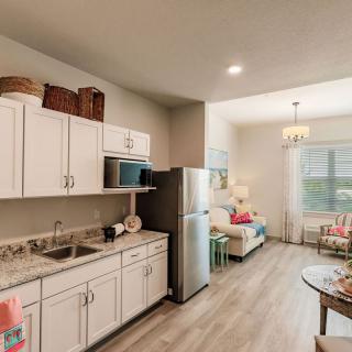 A modern, open-plan kitchen and living area with stylish furnishings and decor.