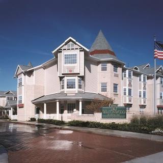 A view of a hotel building with an American flag flying outside.