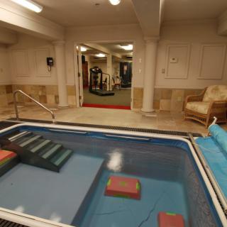 An indoor therapy pool with fitness and relaxation areas.