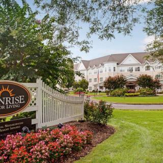A senior living facility with well-maintained gardens and prominent signage.