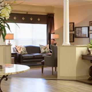 A cozy living room with a leather sofa, decorative cushions, and soft lighting.