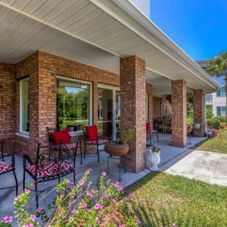 A beautiful brick patio with outdoor seating on a sunny day.