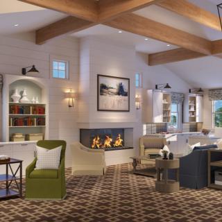 A cozy living room with modern decor featuring a fireplace, comfortable furniture, and wooden beams.