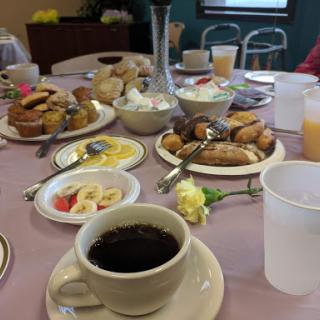 A cozy breakfast table filled with an array of delicious foods and beverages.