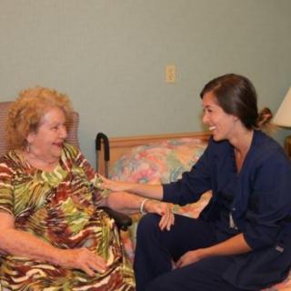 A nurse providing care to an elderly woman in a comfortable setting.