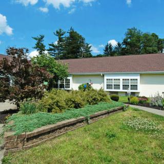 A house with a landscaped garden on a sunny day.