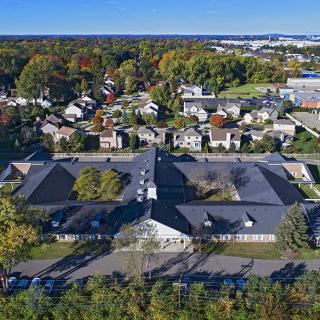 An aerial view of a suburban neighborhood with buildings and trees.
