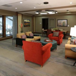 A cozy lobby area featuring colorful armchairs and a modern interior design.