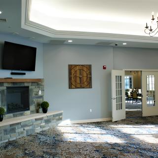 A spacious living room interior with a fireplace, television, and elegant decor.
