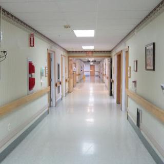 A view of a serene hospital corridor, showcasing the clean and organized environment typical in healthcare settings.