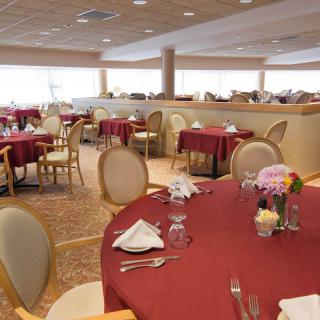 An elegant restaurant dining area with tables set for guests.