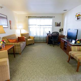 A cozy living room with comfortable seating and a television.