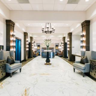 Luxurious hotel lobby with marble floors and elegant seating.