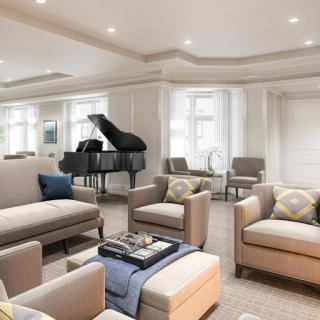 A stylish and modern living room featuring comfortable seating and a grand piano.