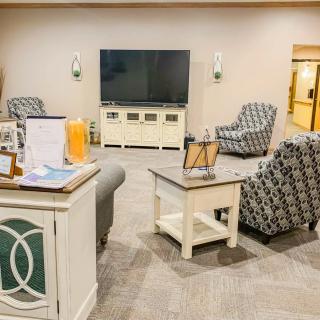 A cozy living room with comfortable seating and a large television, showcasing elegant interior design.