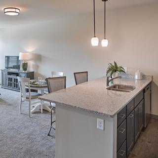 Modern open-concept kitchen and dining area with stylish lighting.