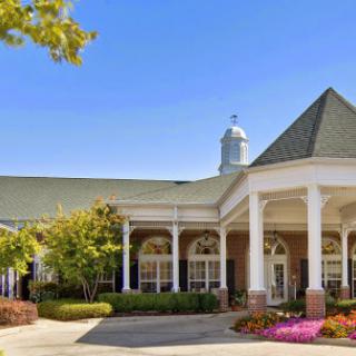 A charming residential building featuring elegant architecture and vibrant landscaping.