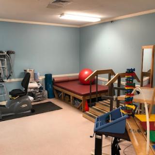 A well-equipped rehabilitation therapy room featuring exercise equipment and rehab tools.