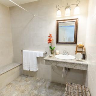 A neatly designed bathroom featuring a modern sink, mirror, and decorative elements.