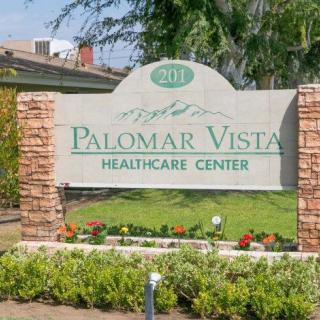 Entrance sign for Palomar Vista Healthcare Center surrounded by landscaping.