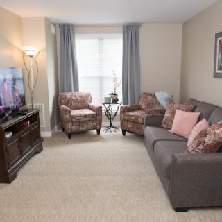 A cozy living room featuring comfortable seating and a television.