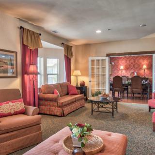 A cozy living room with warm tones, featuring comfortable sofas and elegant decor.