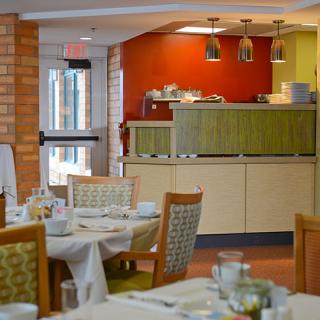 A cozy restaurant dining room with neatly arranged tables and chairs.