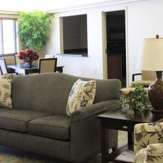 A cozy living room with a comfortable sofa, decorative pillows, and stylish furniture.