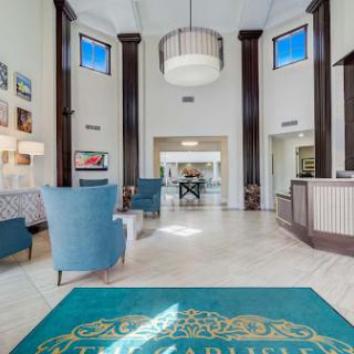 A spacious and elegantly designed lobby with modern furnishings and ample natural light.