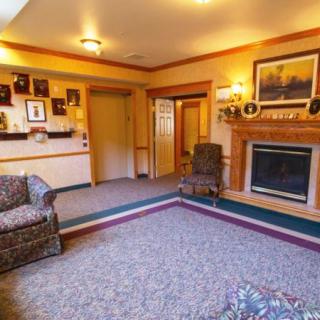 A cozy living room featuring a fireplace, a comfortable seating area, and warm decor.