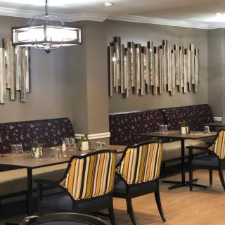 A modern restaurant interior with stylish seating and decorative wall art.