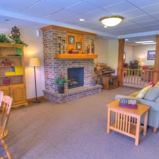 A cozy living room with a brick fireplace and comfortable seating.