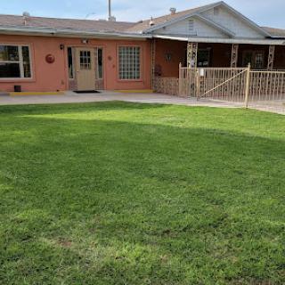 A cozy residential home with a well-maintained lawn.