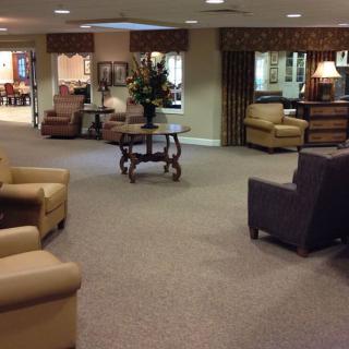 A spacious lobby area with comfortable seating and traditional decor.