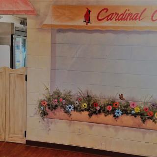 A vibrant mural of a storefront with an array of colorful flowers.