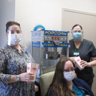 Healthcare staff enjoying a snack break with popcorn.
